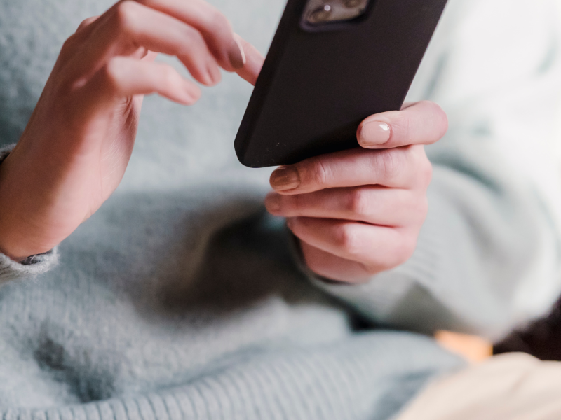 woman looking for unplanned pregnancy support on her phone