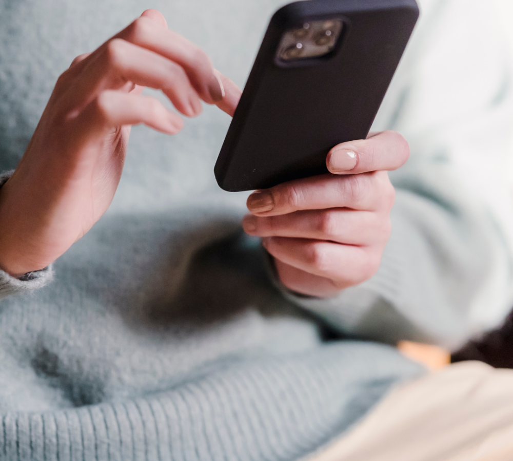 woman looking for unplanned pregnancy support on her phone