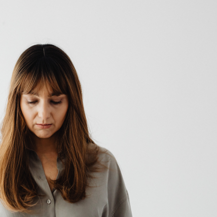 women looking down experiencing emotional effects of abortion